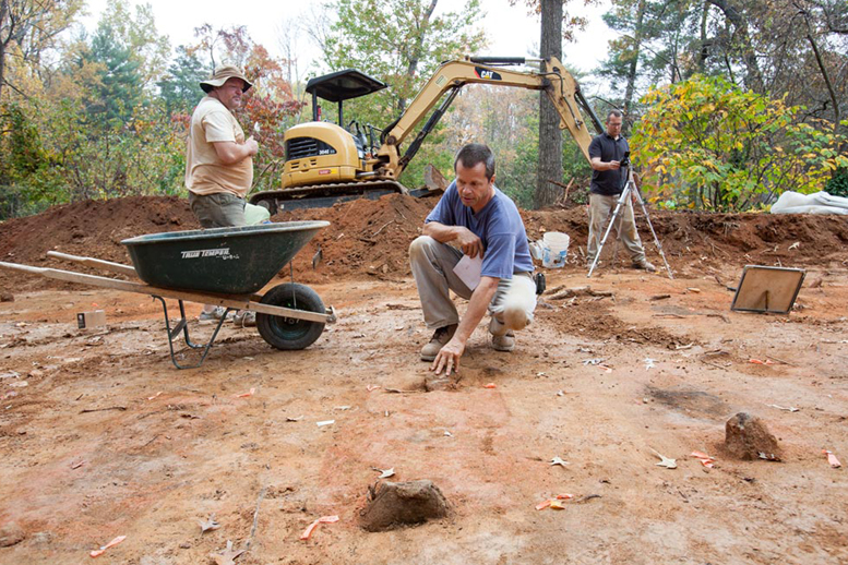 Archeologist digging in unmarked grave site next to UVA Cemetary