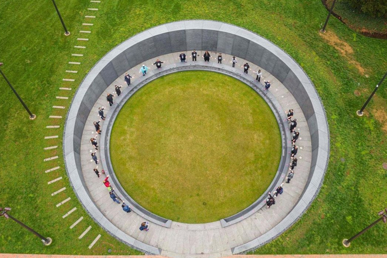 Aerial shot of descendants standing around the memorial interior circle